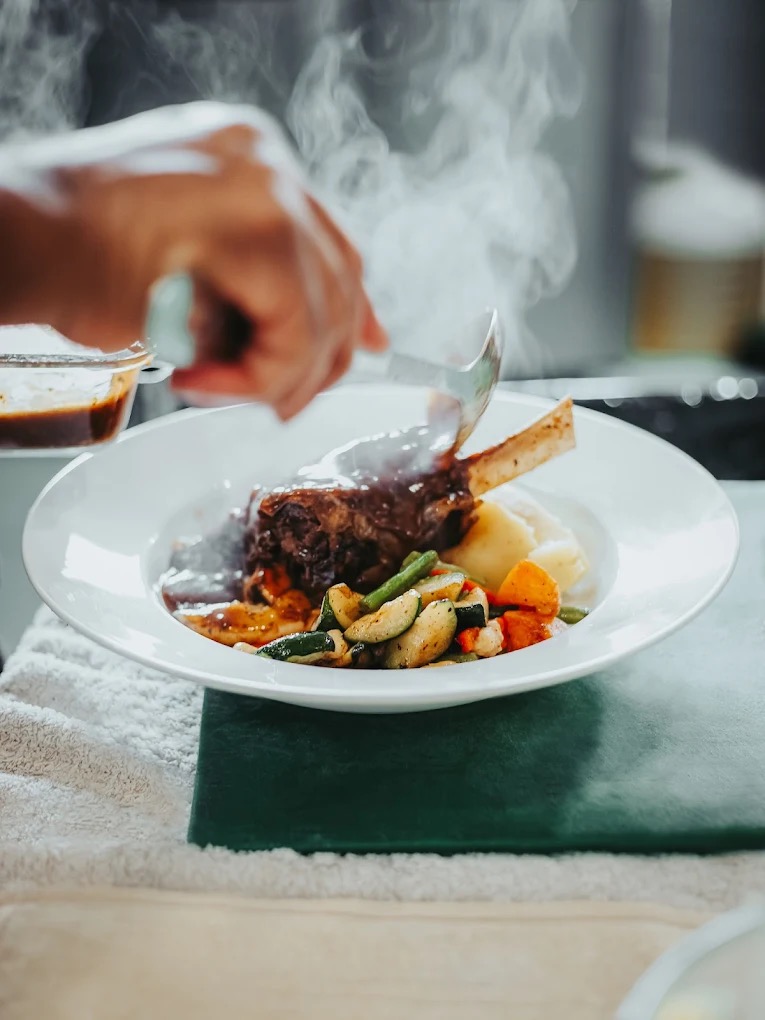 Slow-cooked lamb shank with vegetables and mash at Manor House Gardens