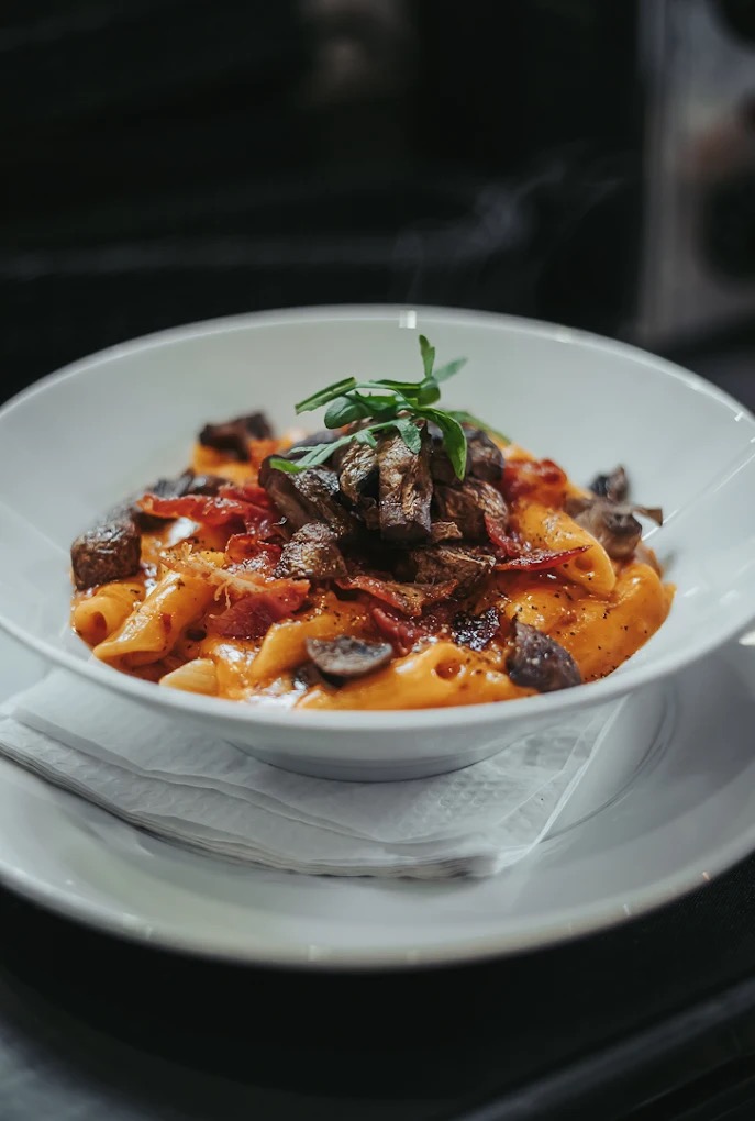 Homemade pasta with mushrooms and crispy bacon at Manor House Gardens