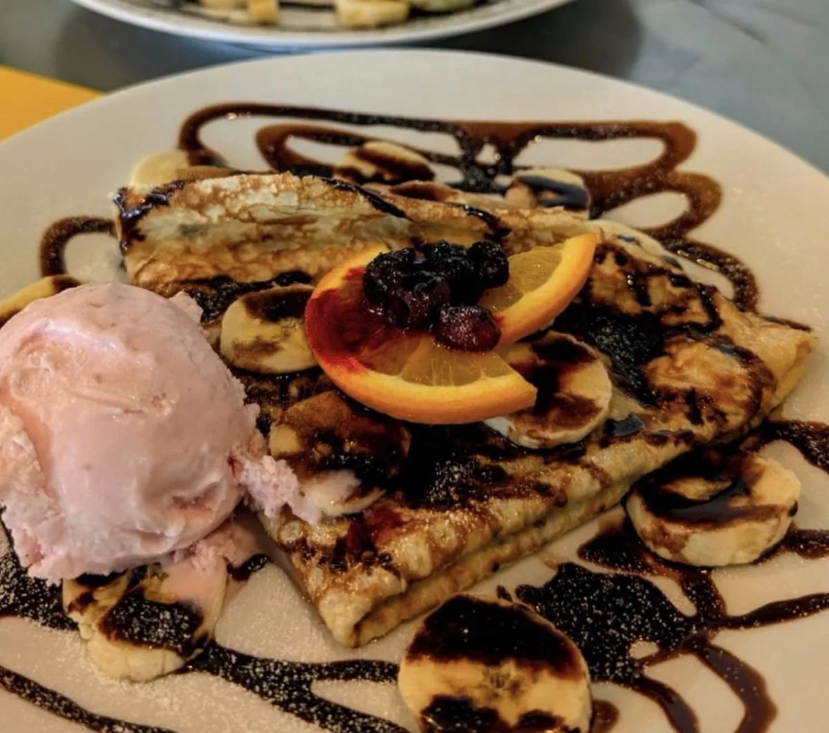 Sweet crepes with ice cream, banana and chocolate